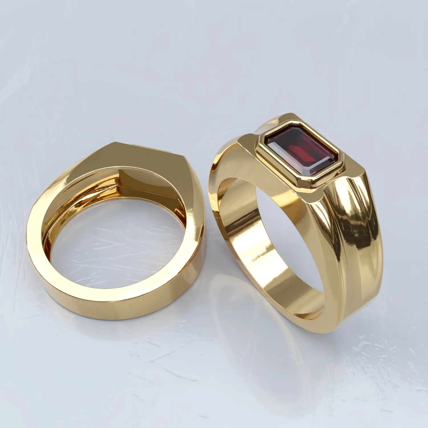 Two gold bands, one set with a red stone