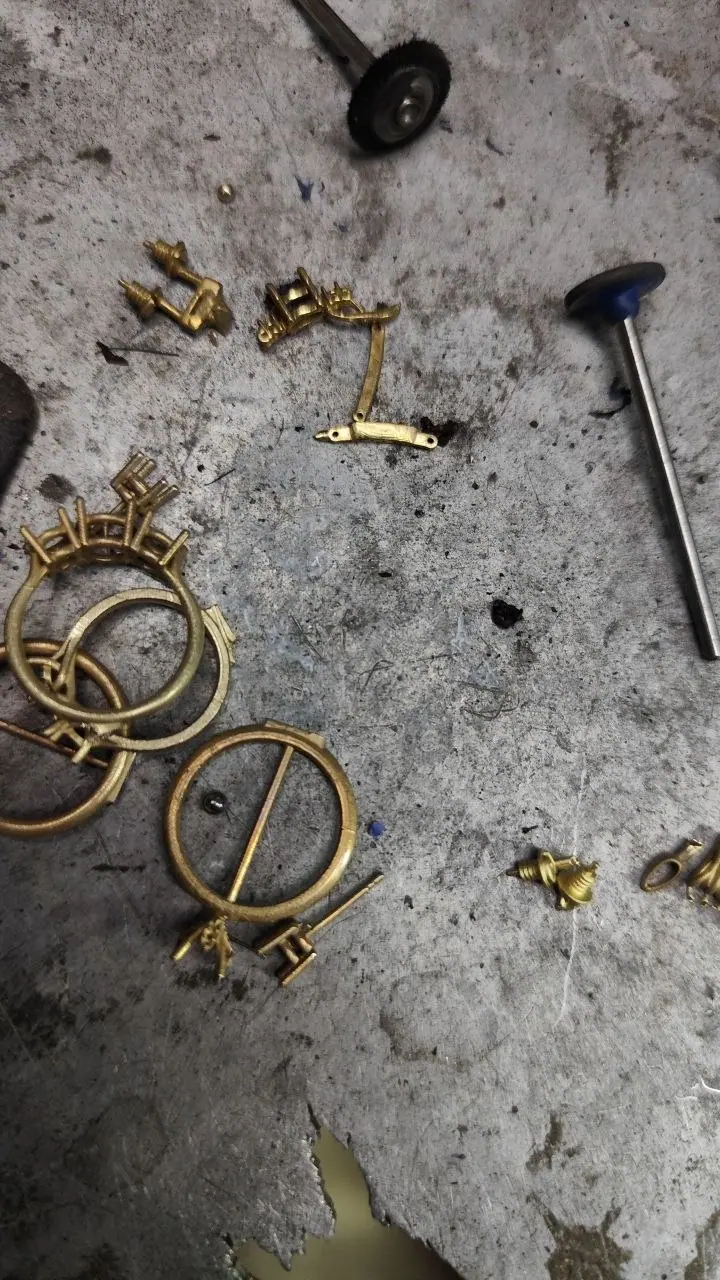 Raw cast parts and ring shanks on the workshop bench