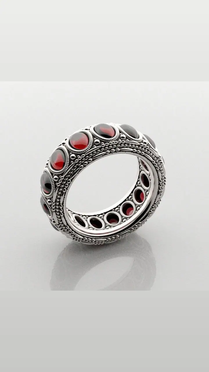 Band ring with oval red stones, beaded edges and an open gallery