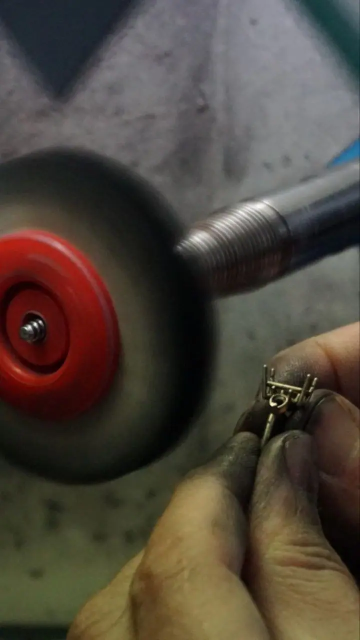 Polishing a small cast part on the bench