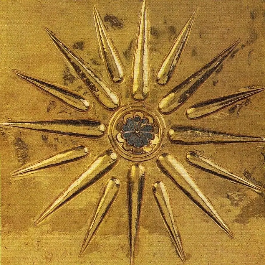 Reference image of a golden sun-ray motif