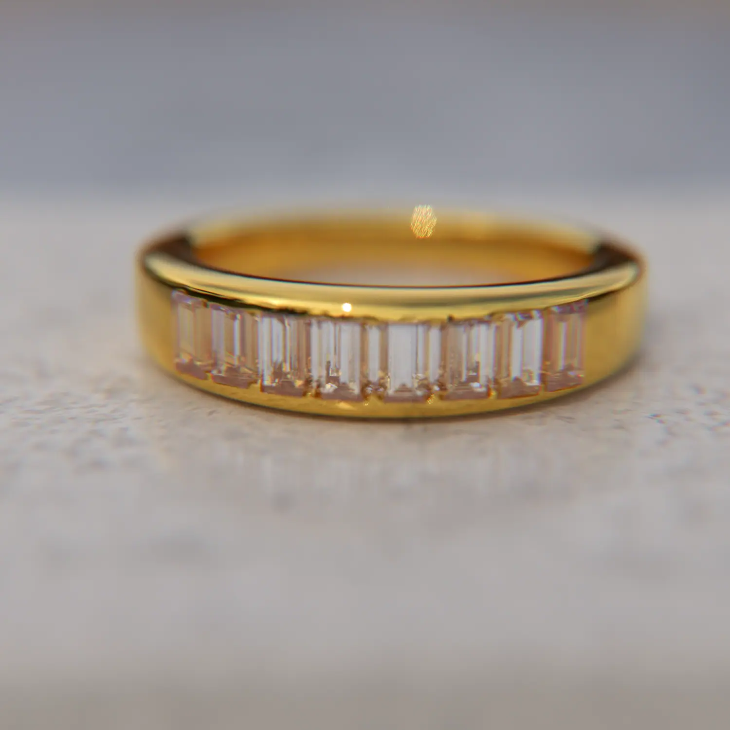 Gold band channel-set with baguette stones