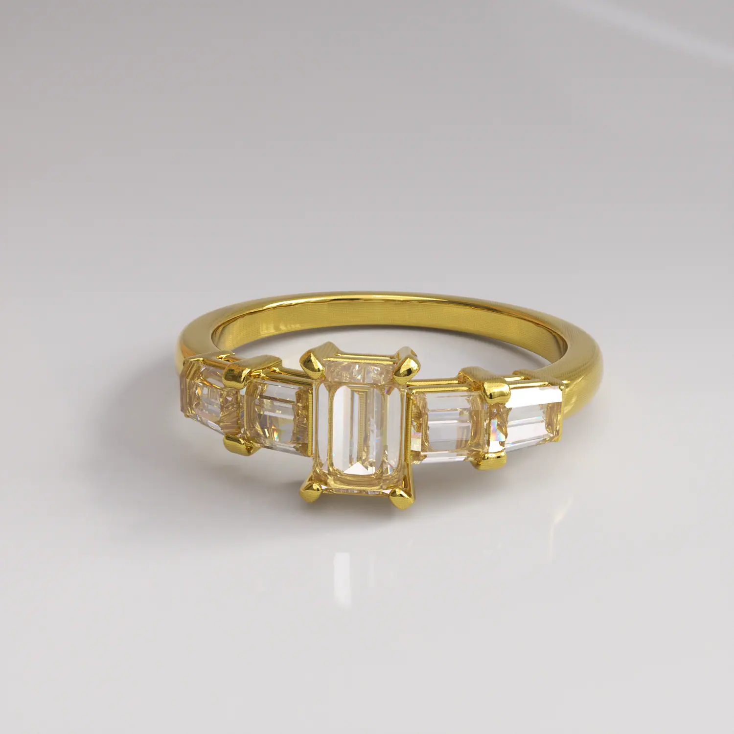 Gold ring with an emerald-cut center and baguette side stones