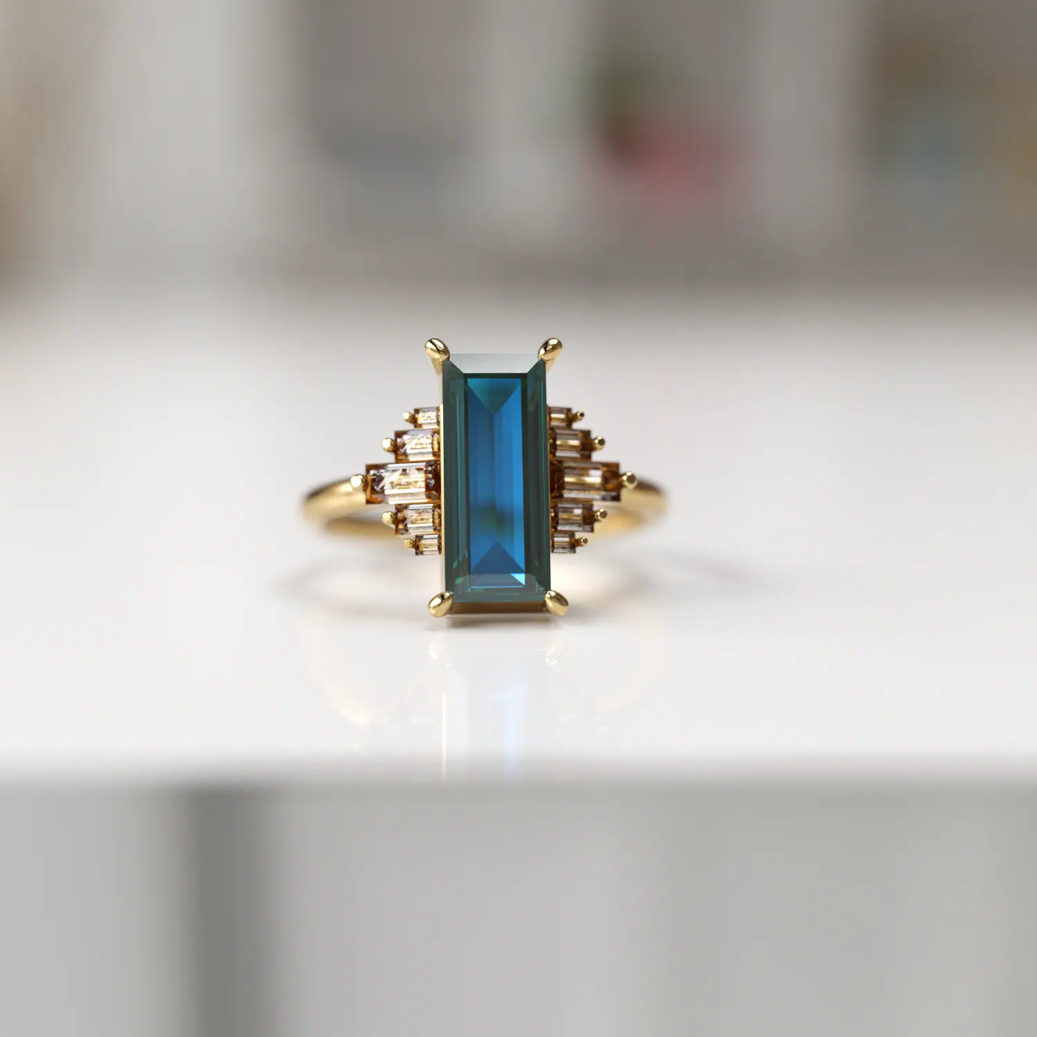 Deco ring with a baguette teal stone and champagne stones