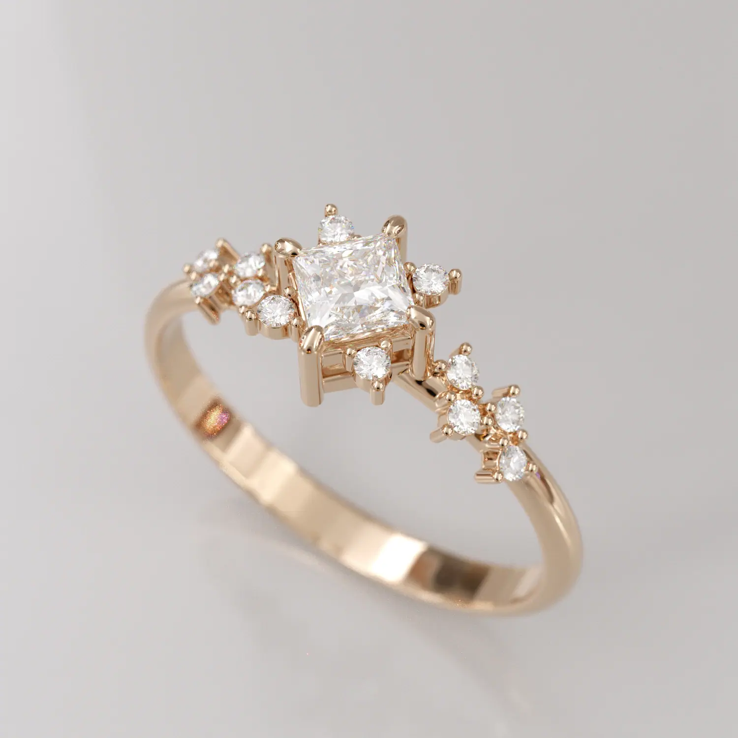 Rose gold ring with a princess-cut diamond and cluster accents